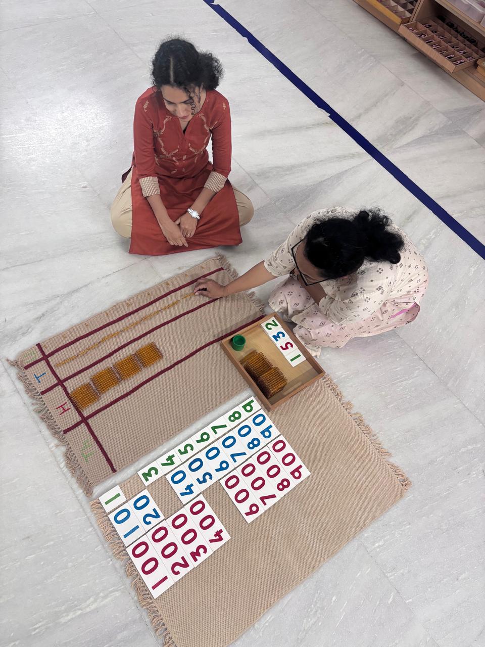 Montessori long rods and number card layout shown from above